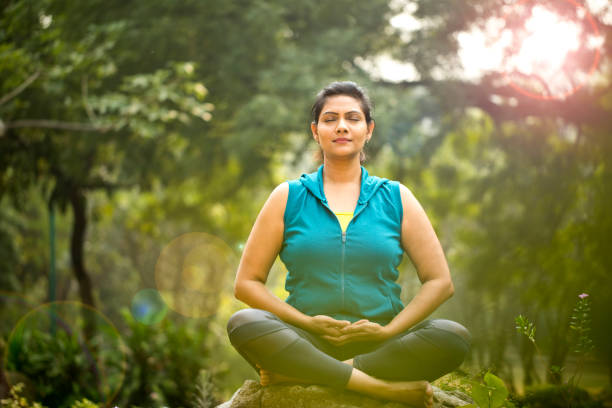 istock Beautiful woman meditating position at park 1193858209