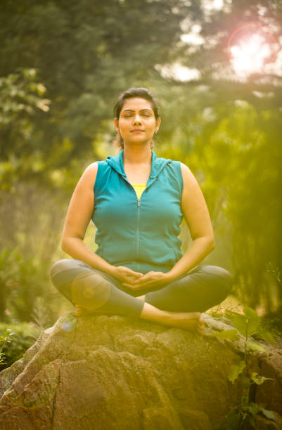 istock Beautiful woman meditating position at park 1193858222