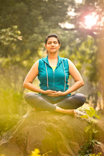 istock Beautiful woman meditating position at park 1193858236