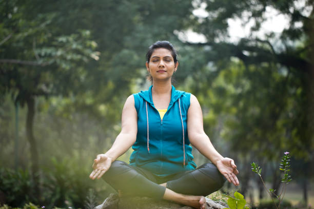 istock Beautiful woman meditating position at park 1193858242