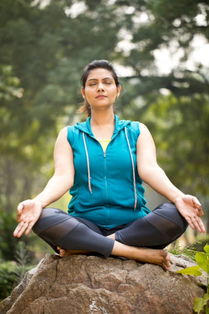 istock Beautiful woman meditating position at park 1193858260
