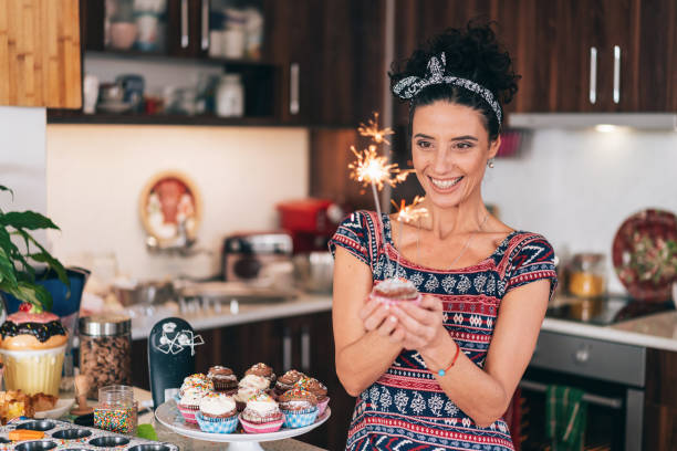 istock Confectioner holding birthday cupcakes 1193858420