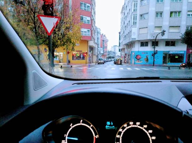 istock Driving, dashboard, red traffic light, apartment buildings. 1193861789
