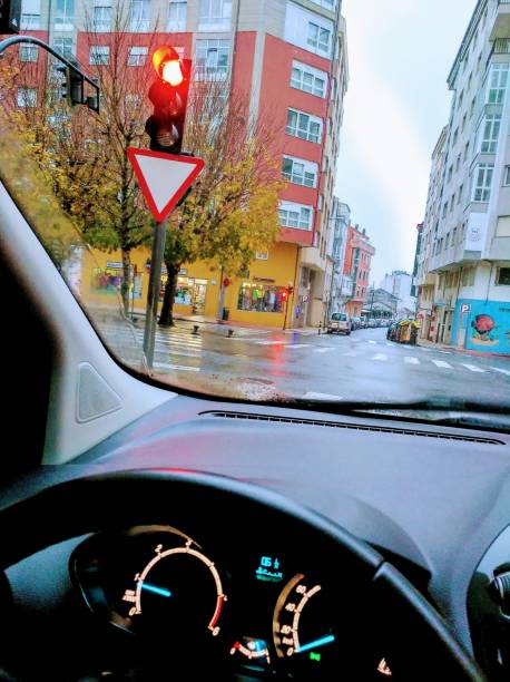 istock Driving, dashboard, red traffic light, apartment buildings. 1193861817
