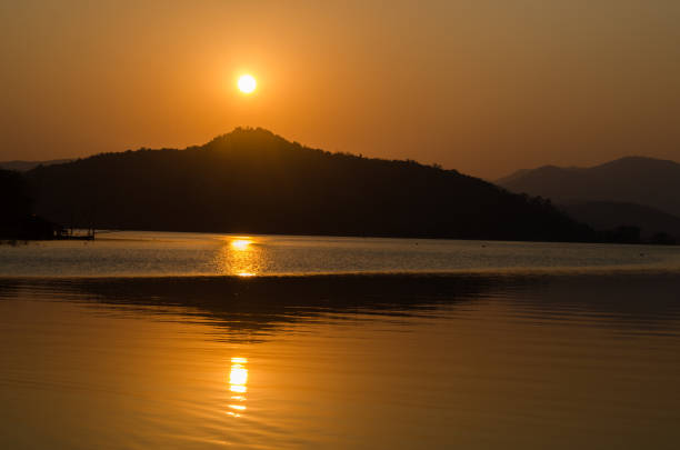 istock Sunset or sunrise over river and mountain 1193863945