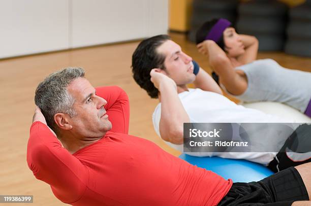 Fitness Class Making Situps Stock Photo - Download Image Now - Exercise Class, Group Of People, Men