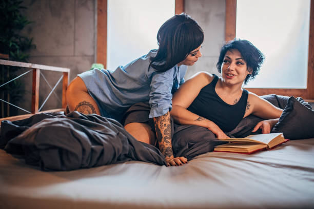 istock Lesbian couple reading book 1193866899