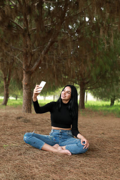 istock young woman sitting and meditating in nature 1193869049