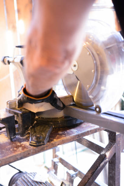 istock Carpenter using electric circular saw in workshop - close-up 1193873477