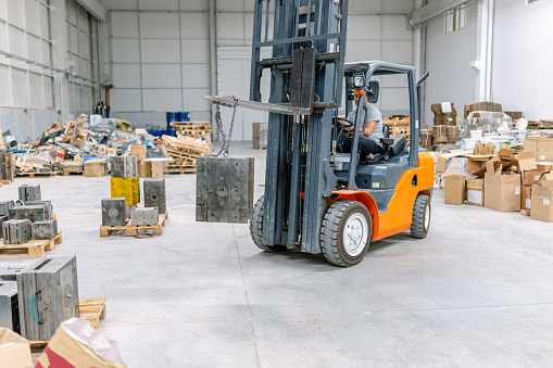 Man driving a forklift truck in the warehouse