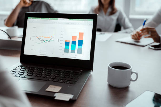 istock Graphs on screen of laptop in board room 1193881592