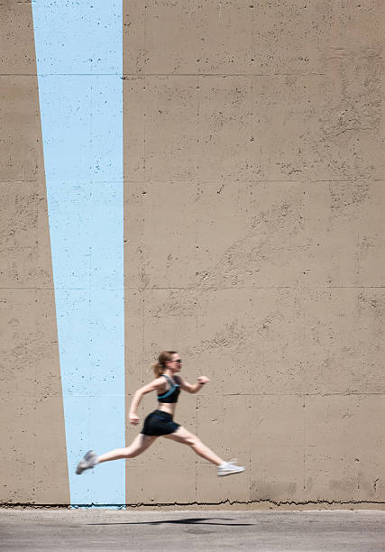 istock Very fit woman runs and jumps high 119388307