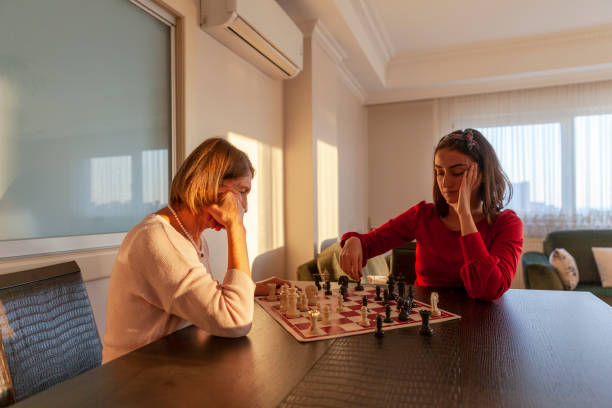 istock Grandmother playing chess granddaughter 1193883670