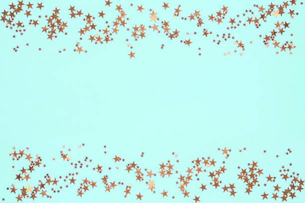 istock Frame from golden stars glitter confetti on blue background. Festive backdrop. 1193892107