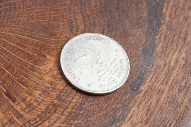 istock old vintage silver dollar on wooden background 1193894086
