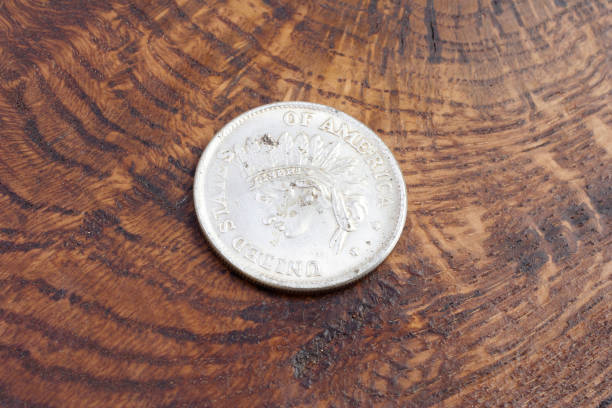 istock old vintage silver dollar on wooden background 1193894148