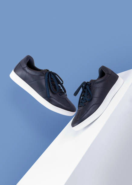 istock dark blue sneakers shoes floating on a white box on a blue background side and front view product mood shot 1193894186