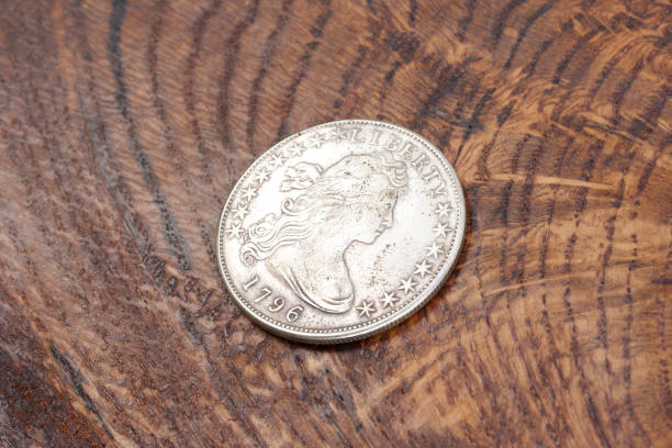 istock old vintage silver dollar on wooden background 1193894203