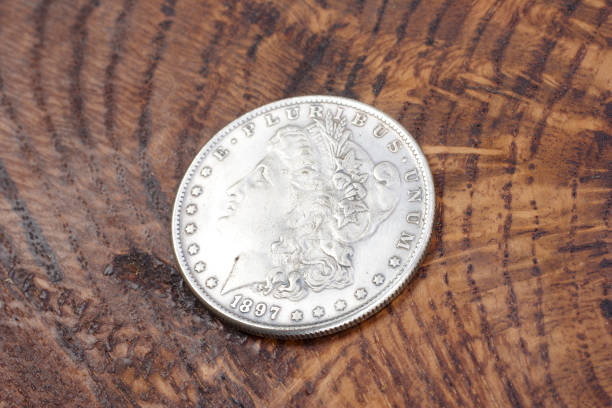 istock old vintage silver dollar on wooden background 1193894208