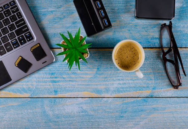 istock External hard disk and USB3.0 reader of memory SD cards on laptop keyboard with glasses and coffee, Backup file every photographer use external storage 1193894312
