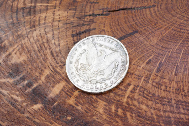 istock old vintage silver dollar on wooden background 1193894343
