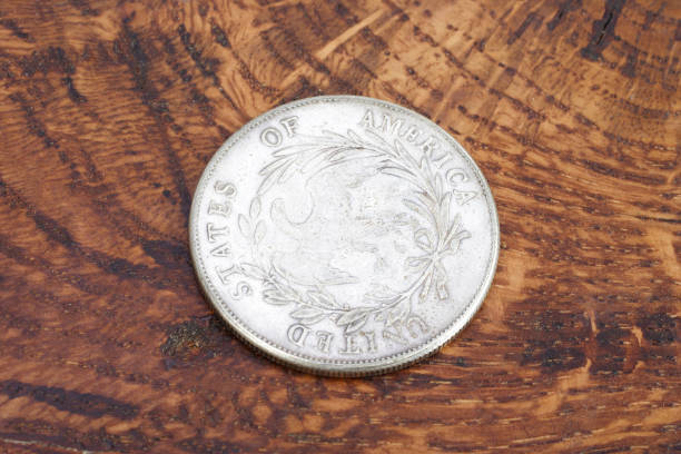 istock old vintage silver dollar on wooden background 1193894348