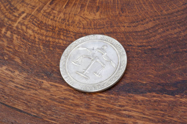 istock old vintage silver dollar on wooden background 1193894390