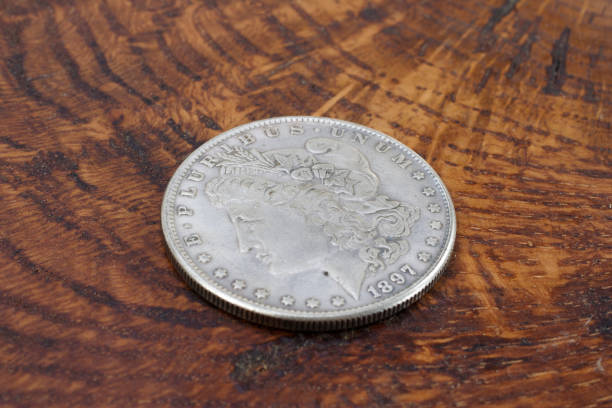 istock old vintage silver dollar on wooden background 1193894423