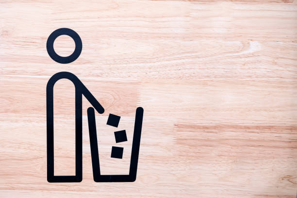 Tidyman throwing waste in recycling bin on gree