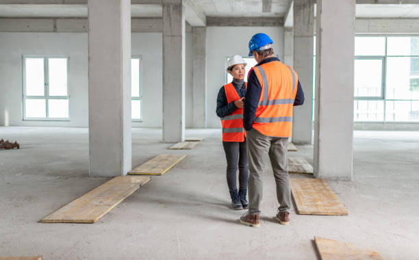 istock Construction Foreman Talking To A Woman At A Construction Site 1193898560