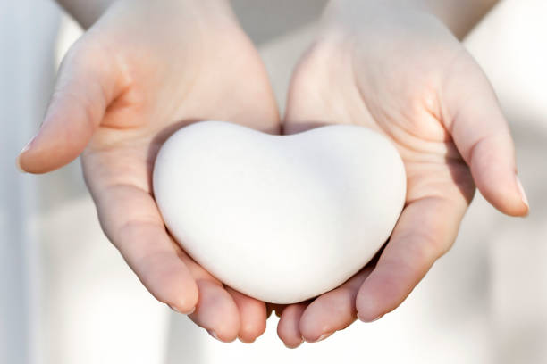 istock Hands are holding a small white heart. Medicine concept. 1193899479