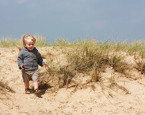 istock little boy on sand dunes 119390076