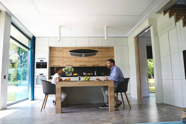 istock Father and son sitting opposite each other in the kitchen 1193904210