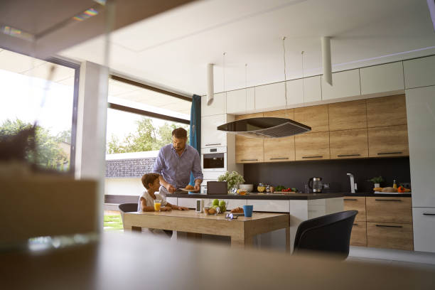 istock Father is cooking breakfast for his little son 1193904228