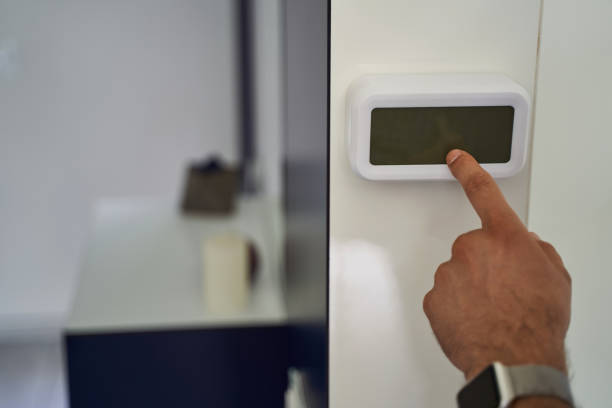 istock Close up of man setting security alarm system 1193904313