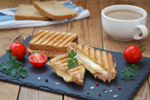 Breakfast with club or toast sandwiches on black tray stock photo