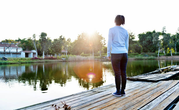 istock Woman standing by the lake 1193905370
