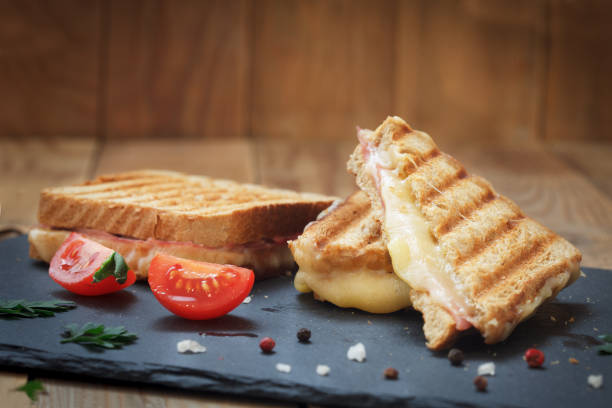 grilled or toasted sandwiches with ham salami, tomato and melted cheese - meteo imagens e fotografias de stock