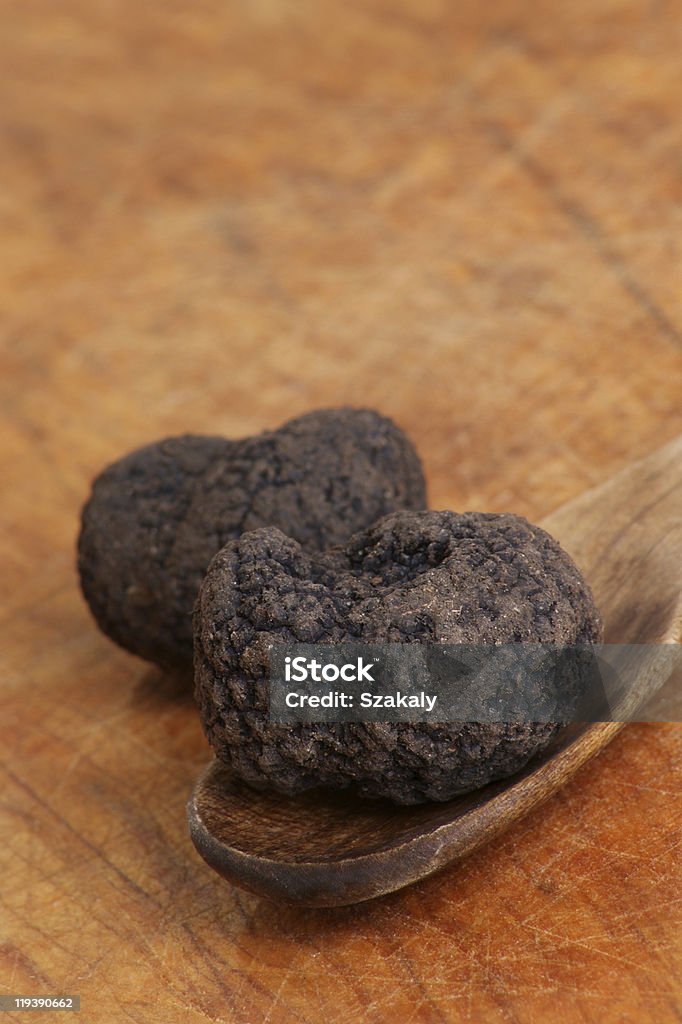 some organic summer truffle on a timber spoon  Brown Stock Photo