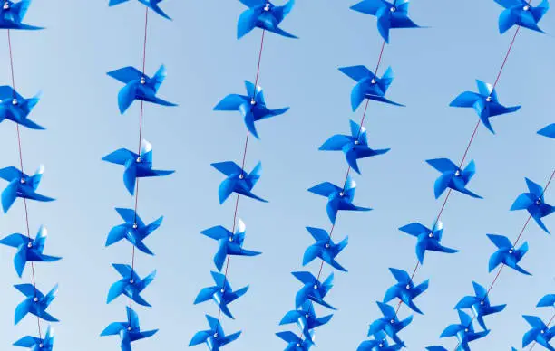 Photo of Groups of pinwheels hanging in a row