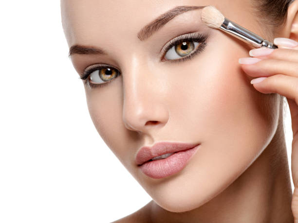 istock Beautiful woman applying eyeshadow use makeup brush 1193906822