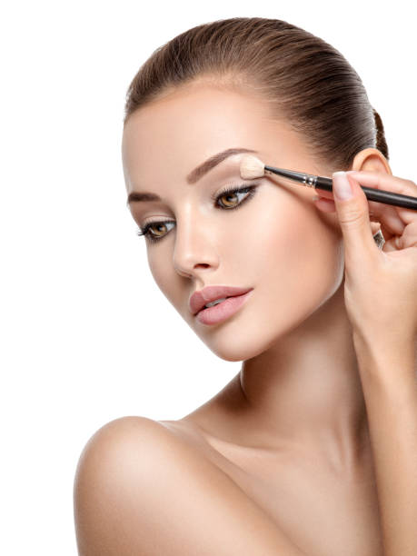 istock Beautiful woman applying eyeshadow use makeup brush 1193906824