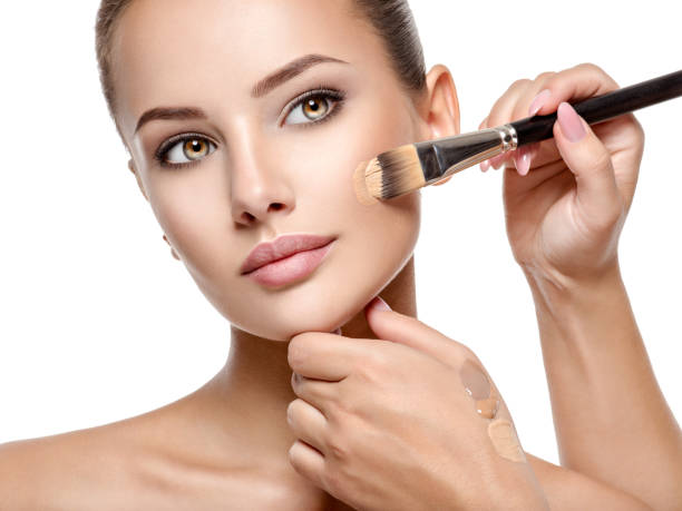 istock Makeup artist applying liquid tonal foundation  on the face 1193906828