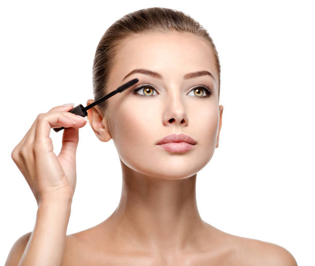 istock woman applying cosmetic mascara on eyelashes using curling brush 1193906835