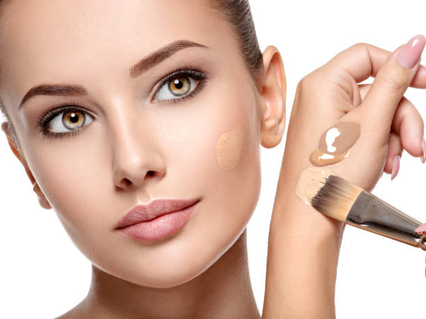 istock Makeup artist applying liquid tonal foundation  on the face 1193906848