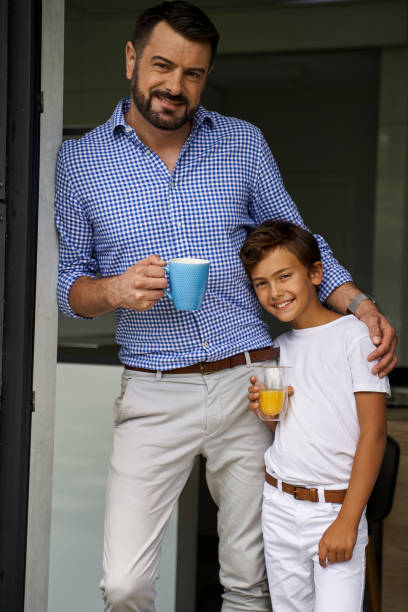 istock Happy father standing with coffee near his son 1193906870