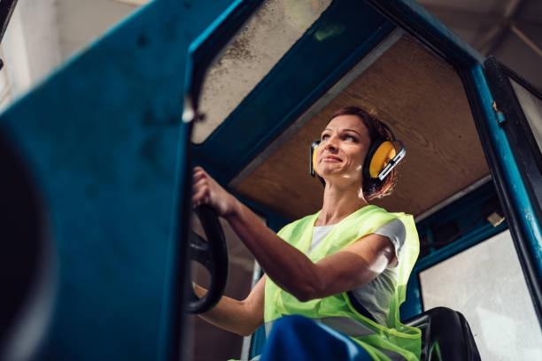 istock Woman forklift operator driving vehicle 1193906896