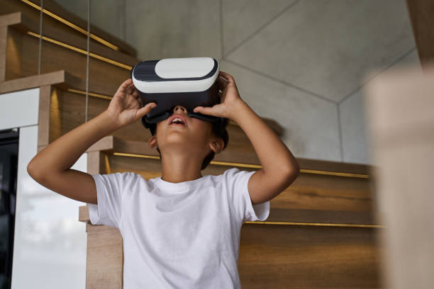 istock Little boy experiencing virtual reality at home 1193906904