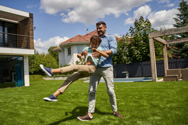 istock Happy man is holding up his son by hands 1193906962