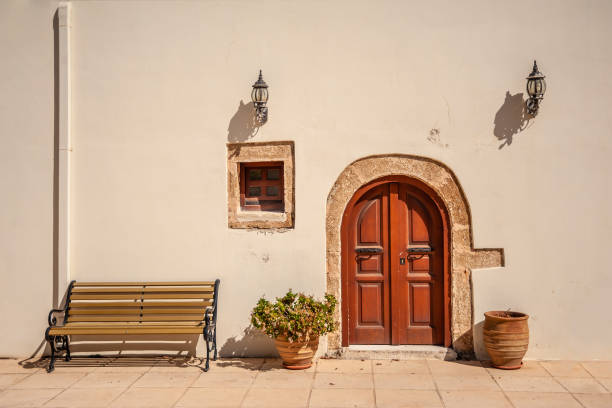 Bench on a background of a wall with doors and lamps